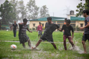 A game of soccer in the rain.