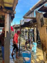 Cleaning between the wooden houses on stilts
