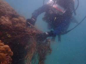 Local community member removing a ghost net