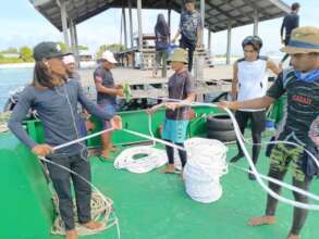 Local youths preparing ropes for the mooring buoys