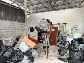 A local islander preparing trash to be shipped out