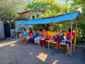 Parents reading books while waiting for the kids