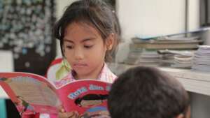 Children reading books in rebuilt library