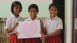 Happy children with rebuilt school