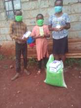 Emma, her brother and sister with their supplies