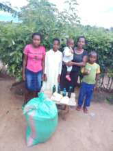 Rose from Kitui with family and their supplies