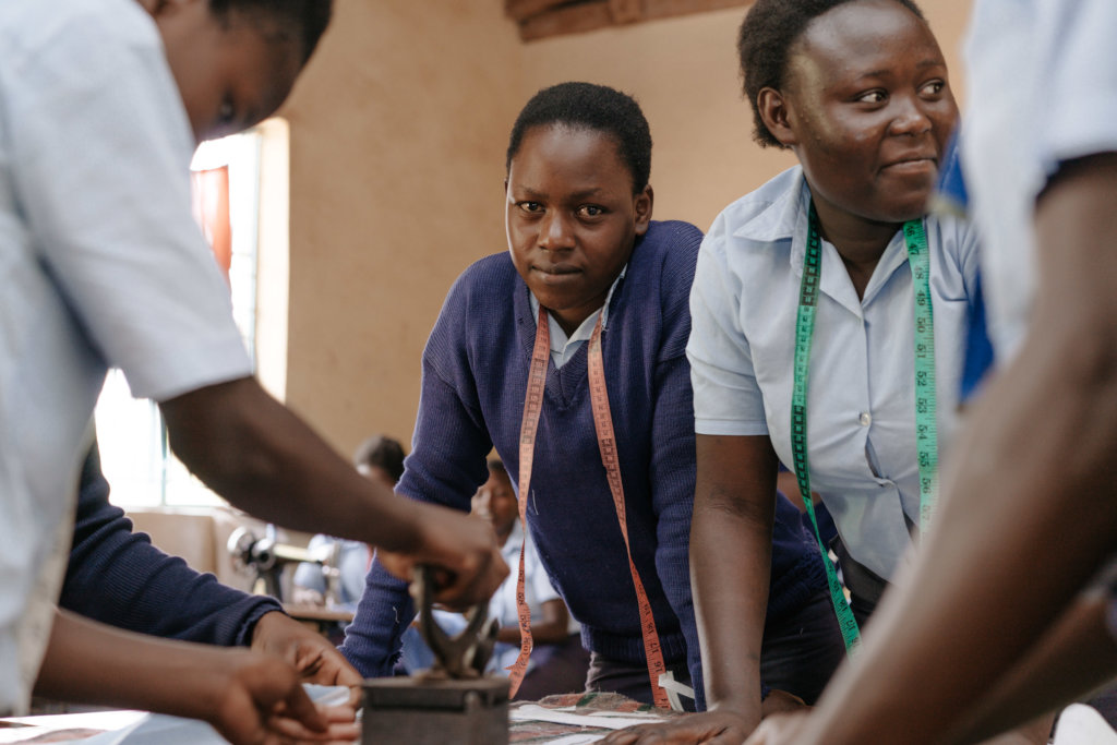 Fashion and Dressmaking students using a coal iron