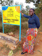 Teacher Jescah showing the new Seed of Hope logo