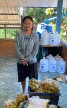 Koon brings crates of tangerines from her farm