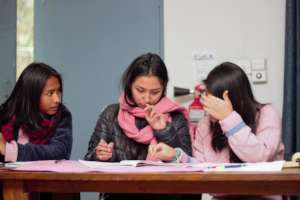 Anu, Bini and Prekchhya working on a proposal