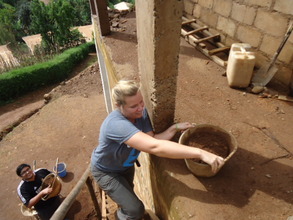 Volunteer Lady carrying sand
