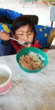 Jose Miguel feeding himself