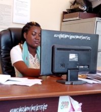 Sania transcribes patients' records at a clinic.