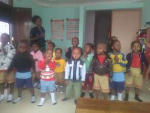 Lois singing with her nursery school students