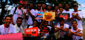 A group of PeaceJam participants march peacefully