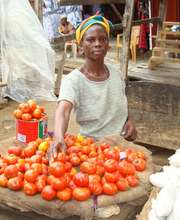 Loan client Janet sells tomatoes in Nsawam market
