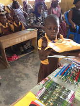 Student receives new uniform and school supplies