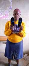 A trainee displays an art and craft piece she made