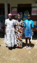 Mother of trainee putting on dress made by trainee
