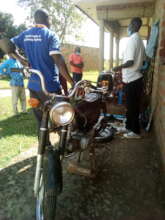 Motorcycle mechanic trainee explaining to audience