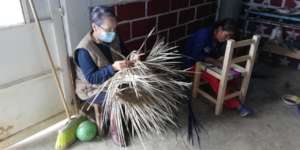 For fun, participants teach Paty how to weave!