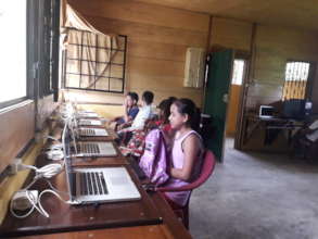 Girls learning to write on the computer