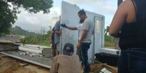 Volunteers setting up a solar shelter in PR