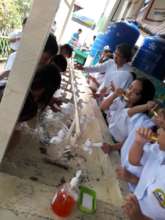 Girls brushing their teeth at school