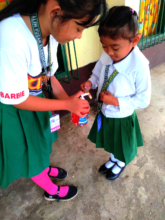 A Mini Nurse assists a young student