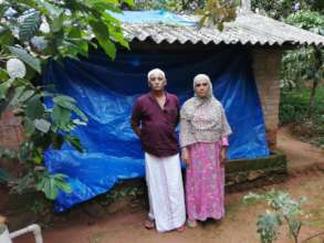 The couple in front of their shed...