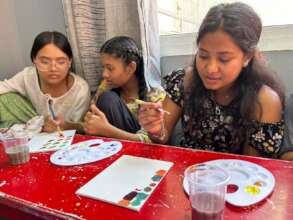 three girls working on an art project