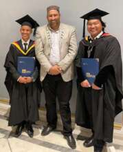 Raja with two recent graduates
