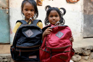 happy girls with their new school bags