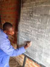 One of our volunteer teaches & the new chalkboard