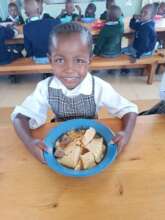Lunchtime with meat, vegetables, and ugali