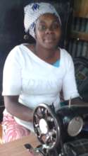 Alimlim with her tailoring machine