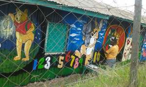 our volunteers drawing  on the daycare wall