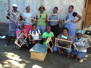 Women learning carpentry to make beehives locally