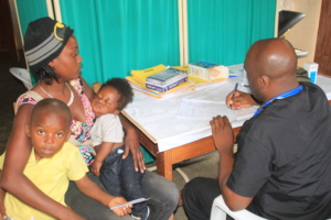 Dr Bernard seeing 2 pediatric patients