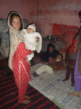 A young  girl with her siblings at home