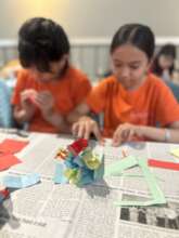 Children participating in a paper flower-making ac