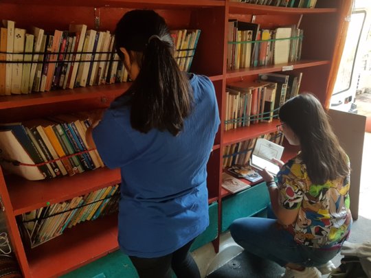 Luliana and Zahra browse Farsi and Arabic books