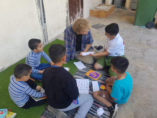 Reading together with teacher Frans