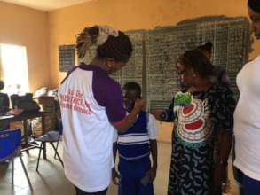 Student fitted with free glasses at ATP Imo