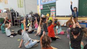 Ms. Lapiers teaches bow basics to kindergarteners