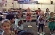 JOY is a kindergartener playing the violin.
