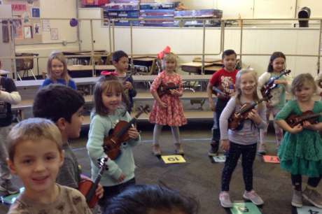 JOY is a kindergartener playing the violin.
