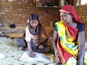 Vasu reading out a story to her mother.