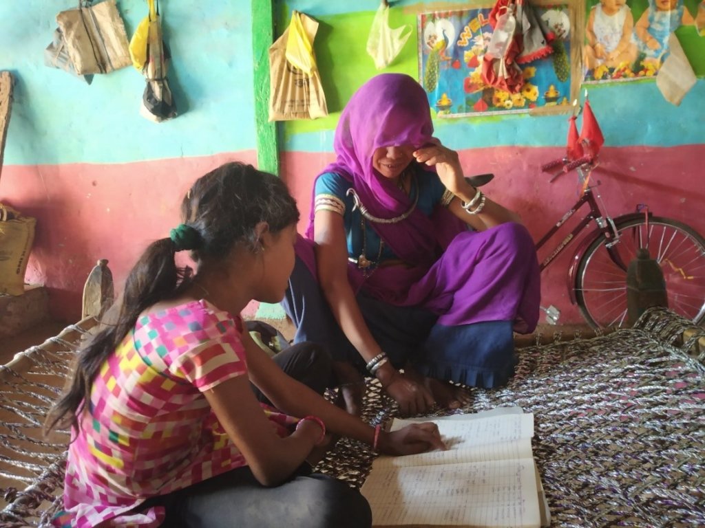 Lali telling her mother what she learnt in school