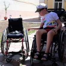 Andrei receives his new wheelchair from Motivation